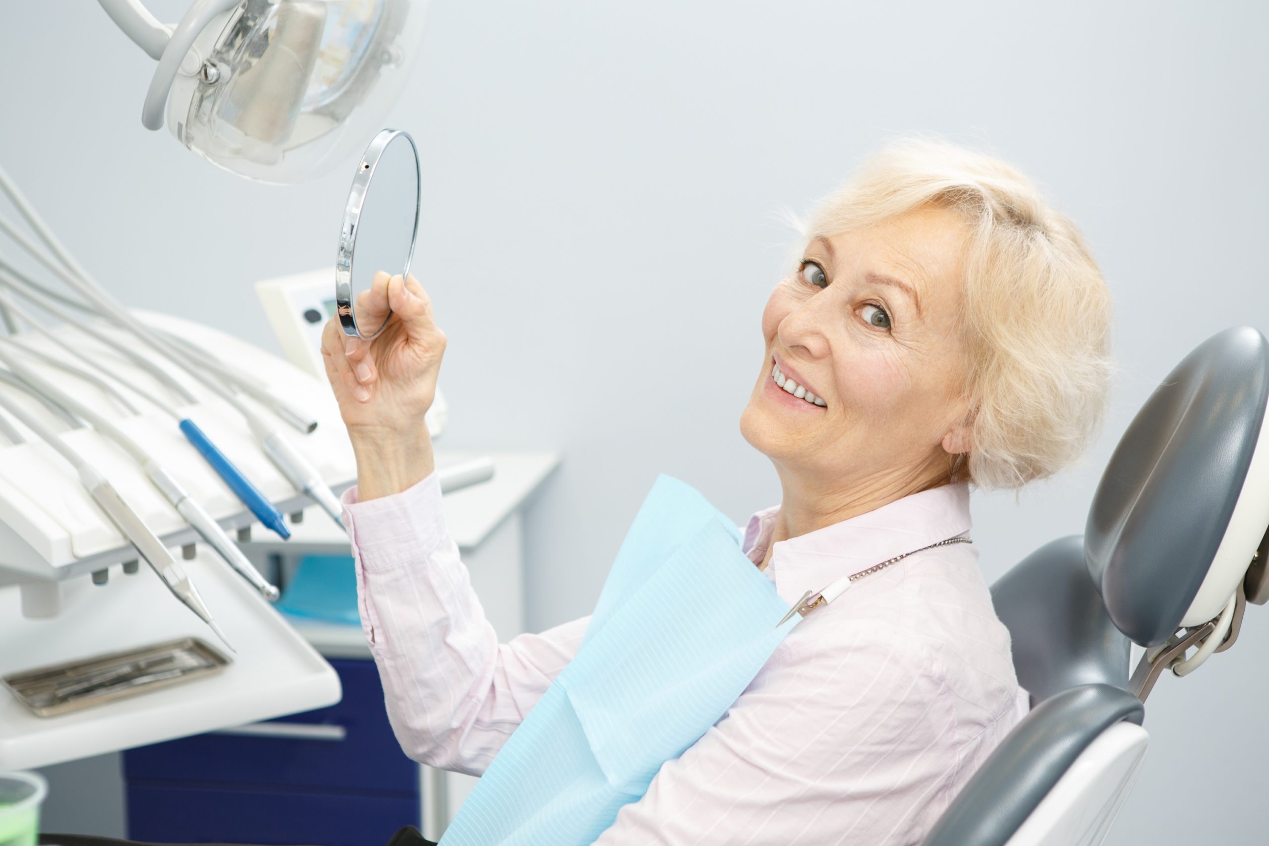 woman sitting in a dental chair getting ready to get dental implants